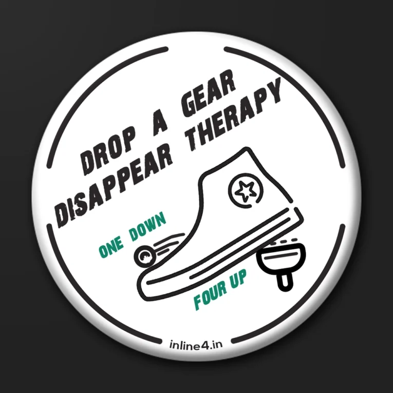 White badge with bold black text reading "Drop A Gear, Disappear Therapy," and an illustration of a boot shifting a motorcycle gear lever
