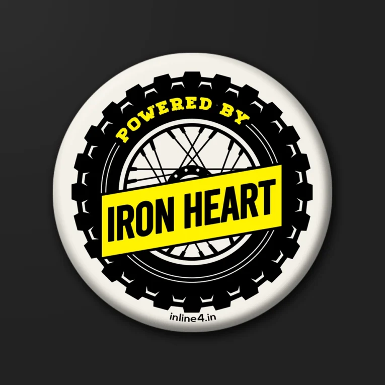 Cream badge styled as an off-road tyre with a spoked wheel graphic and a yellow "Powered By Iron Heart" banner