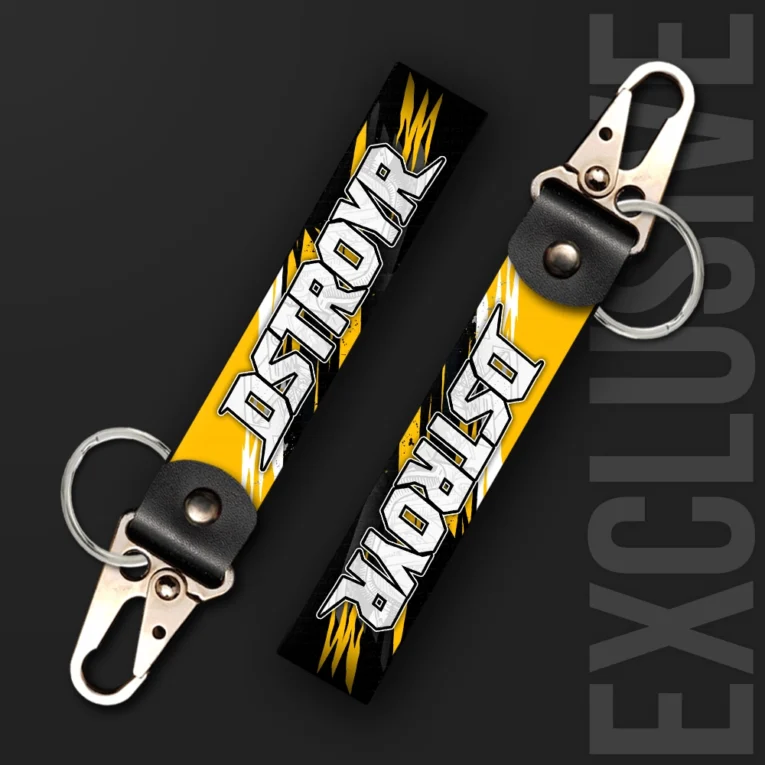 Inline-4 Dstroyr keychain strap with a scratched-metal 'DSTROYR' wordmark on a black and yellow lightning-bolt background, swivel hook clip + keyring
