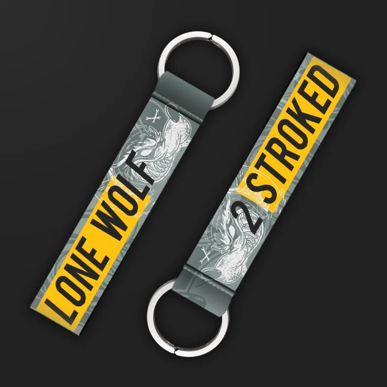 Inline-4 Lone Wolf keychain strap with a grey wolf illustration and '2 STROKED' and 'LONE WOLF' text on a yellow and grey background, double keyring