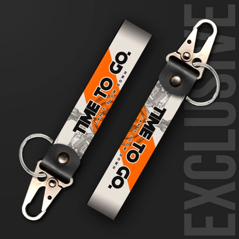 Inline-4 Time to Go keychain strap with black 'TIME TO GO' and orange 'CAN'T SLOW DOWN' text over a sketched engine illustration, swivel hook clip + keyring