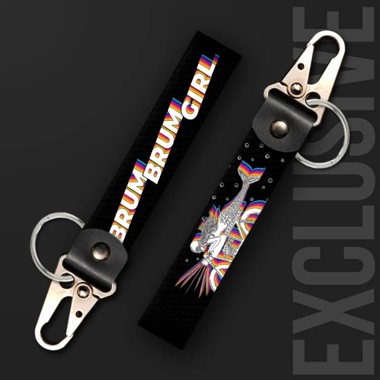 Inline-4 Brum Brum Girl keychain strap with rainbow-gradient 'BRUM BRUM GIRL' lettering and a winged rider-mermaid illustration on black, swivel hook clip + keyring