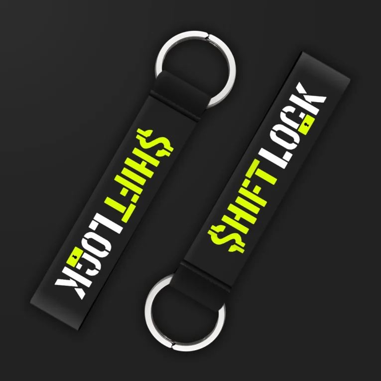 Inline-4 Shiftlock keychain strap with neon-green and white 'SHIFTLOCK' text over a black textured background, double keyring
