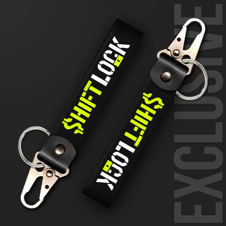 Inline-4 Shiftlock keychain strap with neon-green and white 'SHIFTLOCK' text over a black textured background, swivel hook clip + keyring