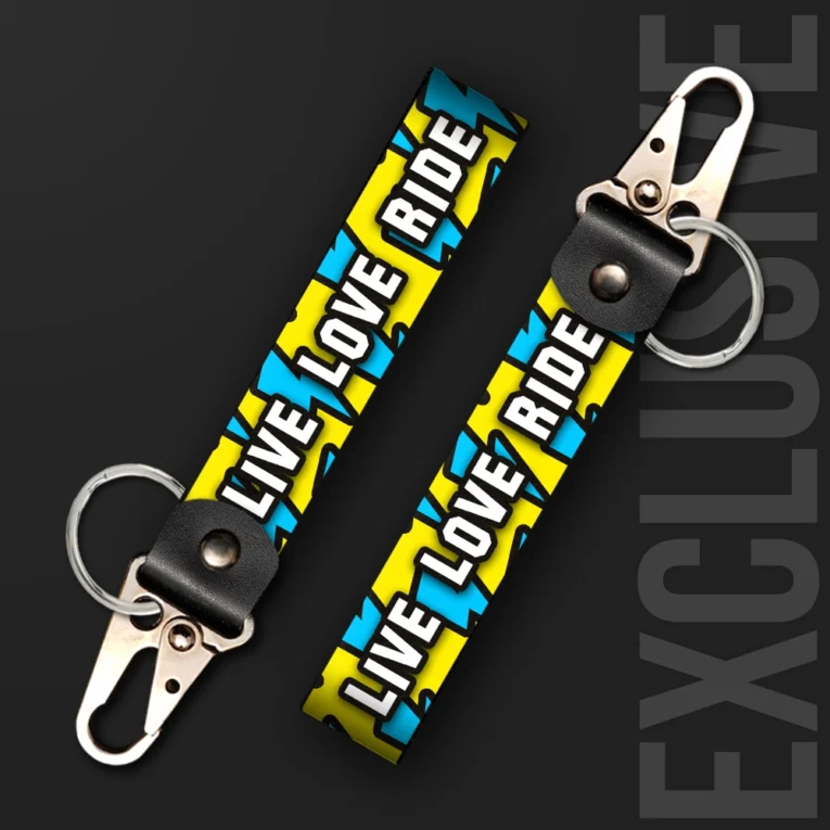 Inline-4 Live Love Ride keychain strap with bold white 'LIVE LOVE RIDE' text over a yellow and blue lightning-bolt pattern, swivel hook clip + keyring