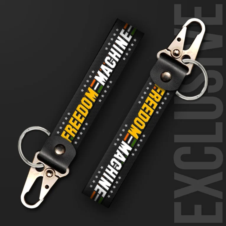 Inline-4 Freedom Machine keychain strap with white and yellow 'FREEDOM MACHINE' text over a star pattern and Indian tricolor stripe, swivel hook clip + keyring