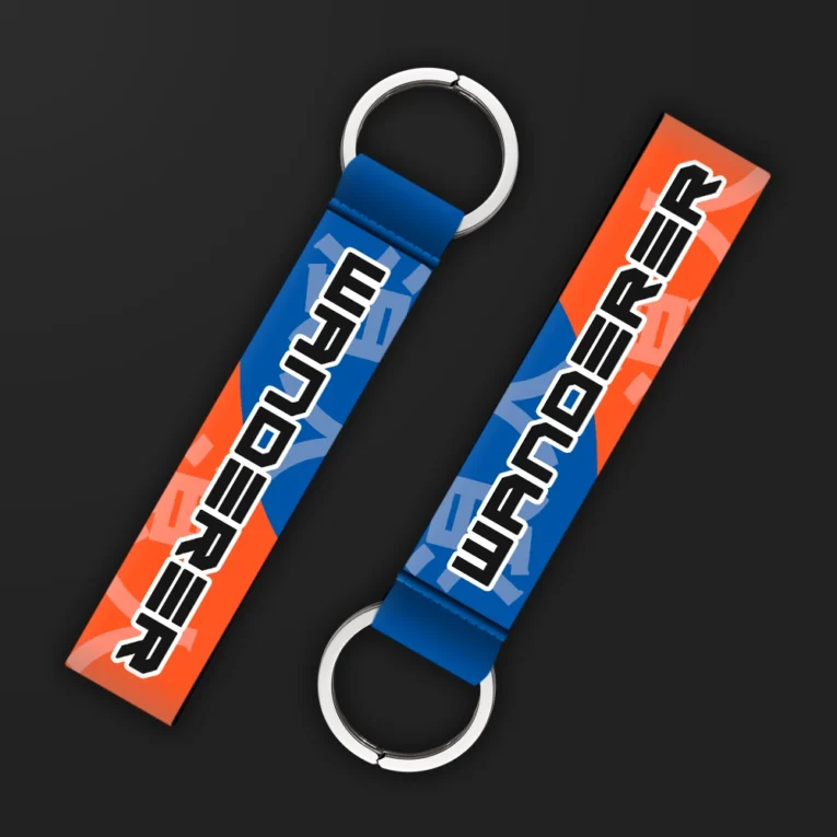 Inline-4 Wanderer keychain strap with bold black 'WANDERER' text over an orange and blue geometric background, double keyring