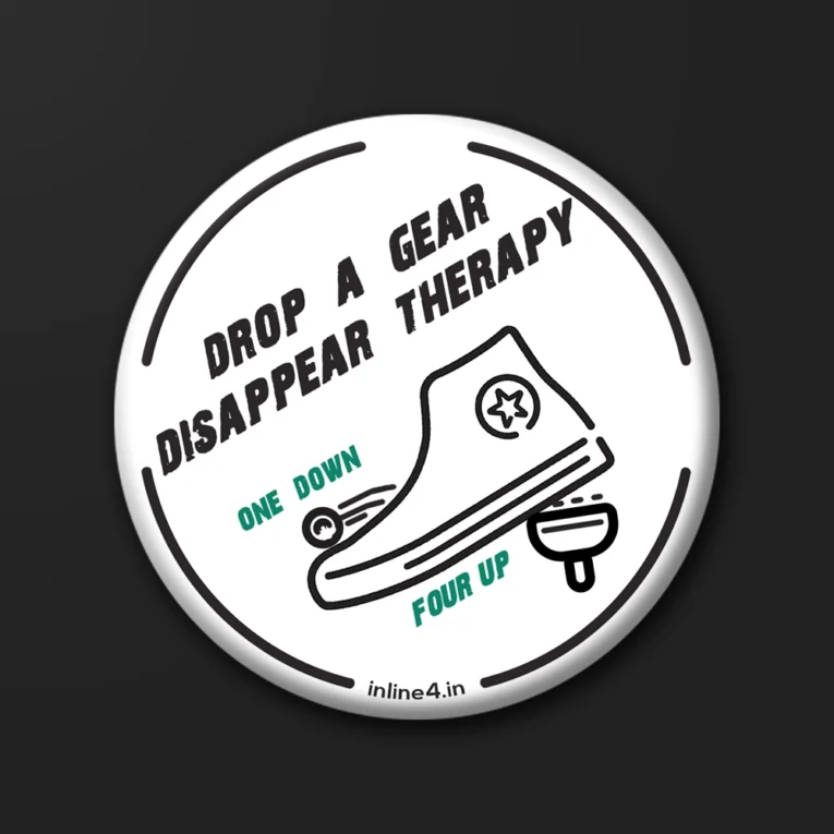 White badge with bold black text reading "Drop A Gear, Disappear Therapy," and an illustration of a boot shifting a motorcycle gear lever