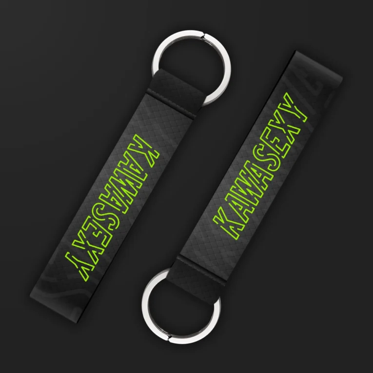 Inline-4 Kawasexy keychain strap with neon-green outlined 'KAWASEXY' text on a black diamond-textured background, double keyring