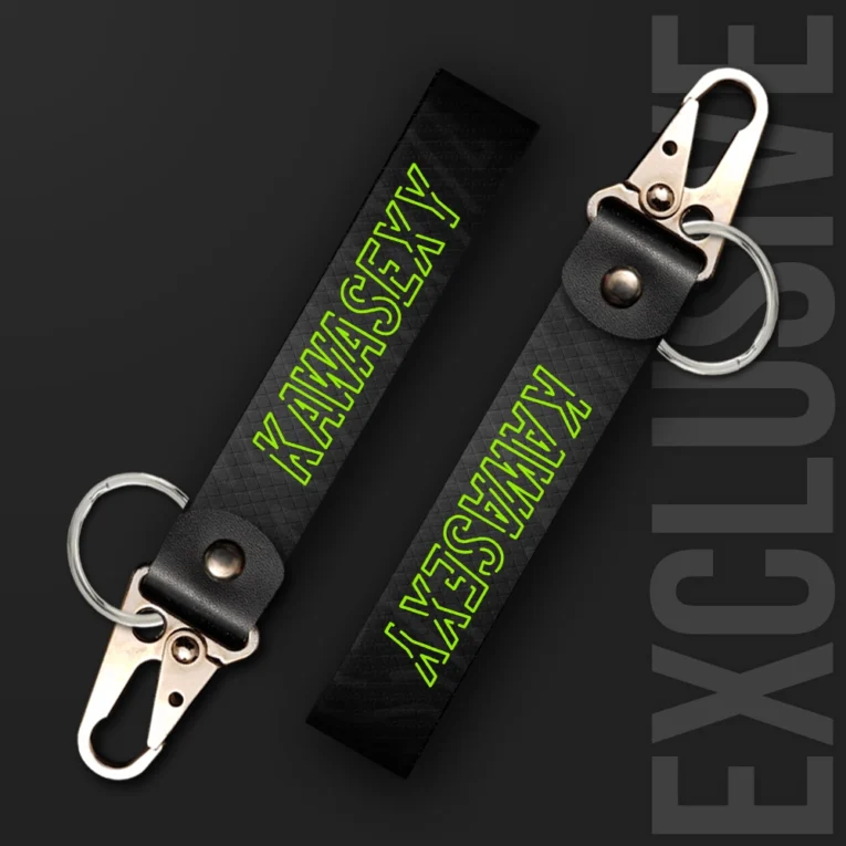 Inline-4 Kawasexy keychain strap with neon-green outlined 'KAWASEXY' text on a black diamond-textured background, swivel hook clip + keyring