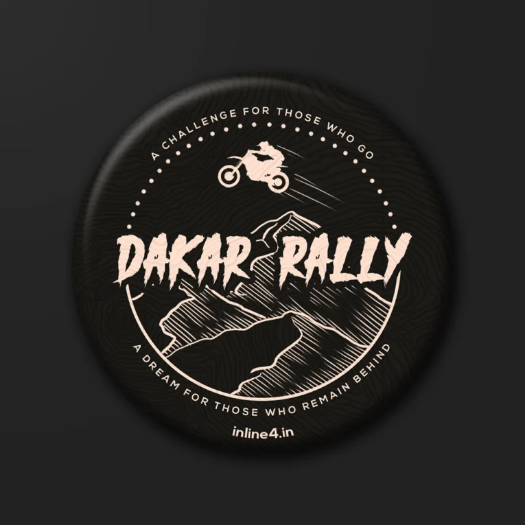 Black badge with a tan illustration of a rider jumping a dirt bike over mountains, bold text reading "Dakar Rally"