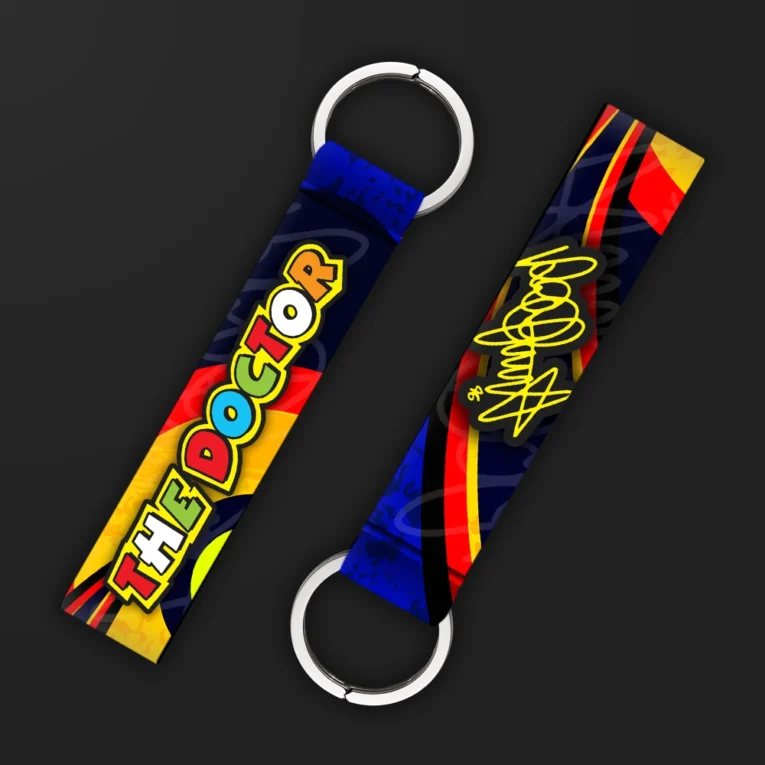 Inline-4 The Doctor keychain strap with colorful bubble-letter 'THE DOCTOR' text and a yellow signature graphic on a red and blue background, double keyring