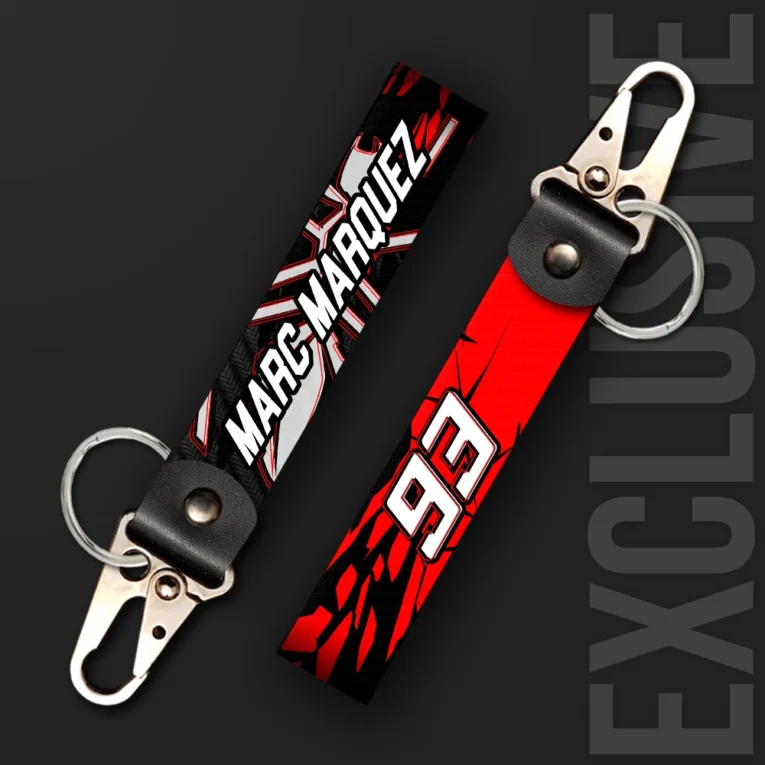 Inline-4 Marc Marquez 93 keychain strap with a bold 'MARC MARQUEZ' wordmark and cracked number 93 graphic on red and black, swivel hook clip + keyring