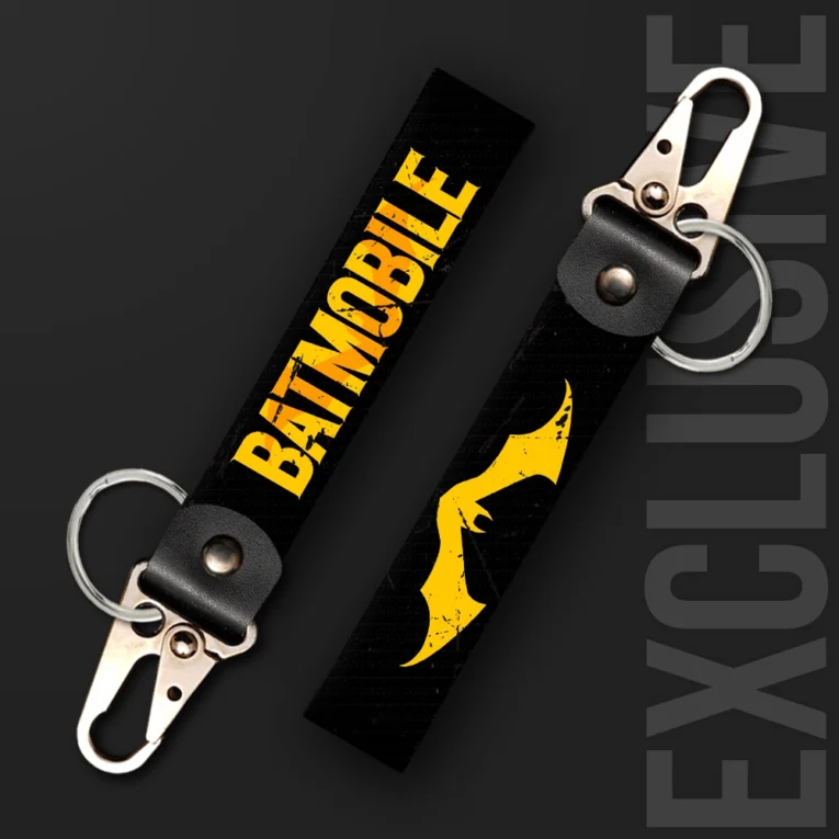 Inline-4 dark rider keychain strap with a bold yellow 'BATMOBILE' wordmark and a stylized bat-wing silhouette on black, swivel hook clip + keyring