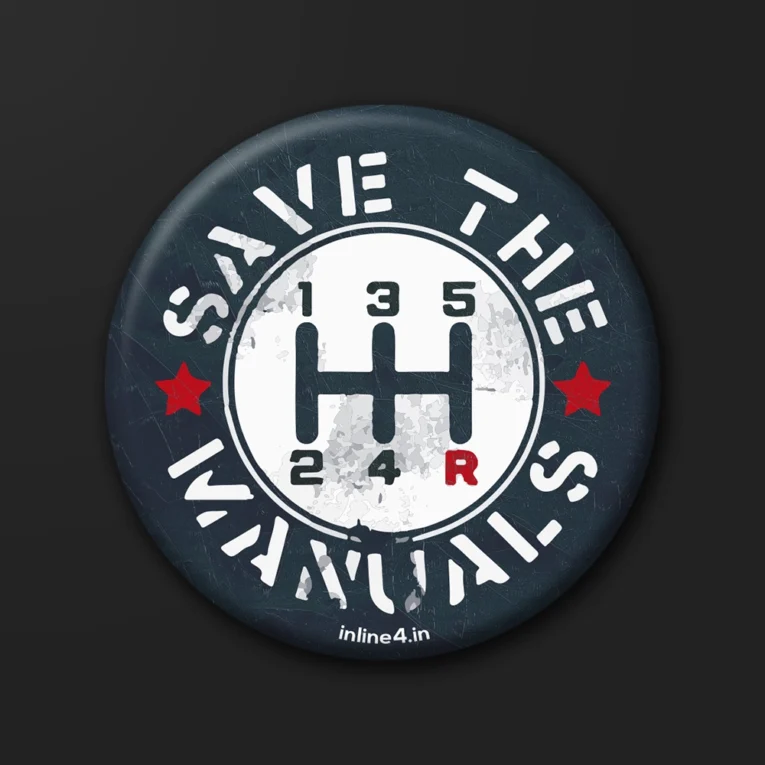 Dark badge with white distressed text reading "Save The Manuals" and a white gear-shift pattern illustration