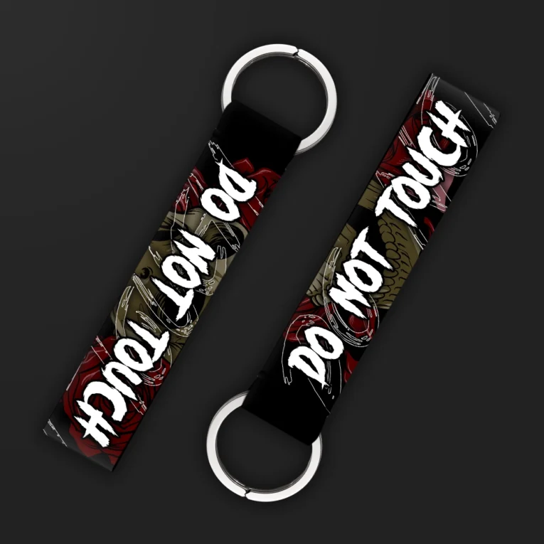 Inline-4 Do not Touch keychain strap with white handwritten 'DO NOT TOUCH' text over a dark gothic snake and rose illustration, double keyring