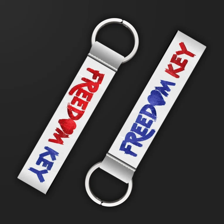 Inline-4 Freedom Key keychain strap with red and blue brush-lettered 'FREEDOM KEY' text on a white background, double keyring