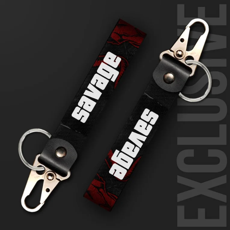 Inline-4 Savage keychain strap with bold white 'SAVAGE' text over a dark red distressed background, swivel hook clip + keyring