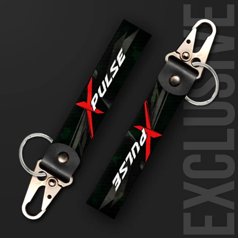 Inline-4 XPulse keychain strap with a red 'X' graphic and white 'PULSE' text over a dark green camo background, swivel hook clip + keyring