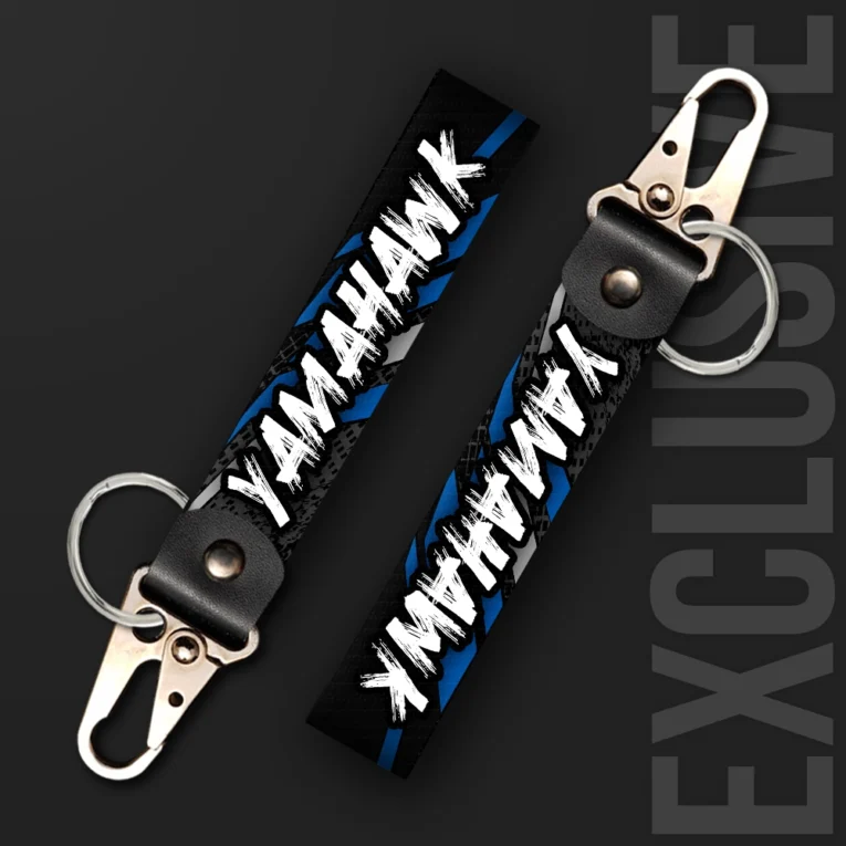 Inline-4 Yamahawk keychain strap with bold white brush-lettered 'YAMAHAWK' text on a black and blue tire-tread background, swivel hook clip + keyring