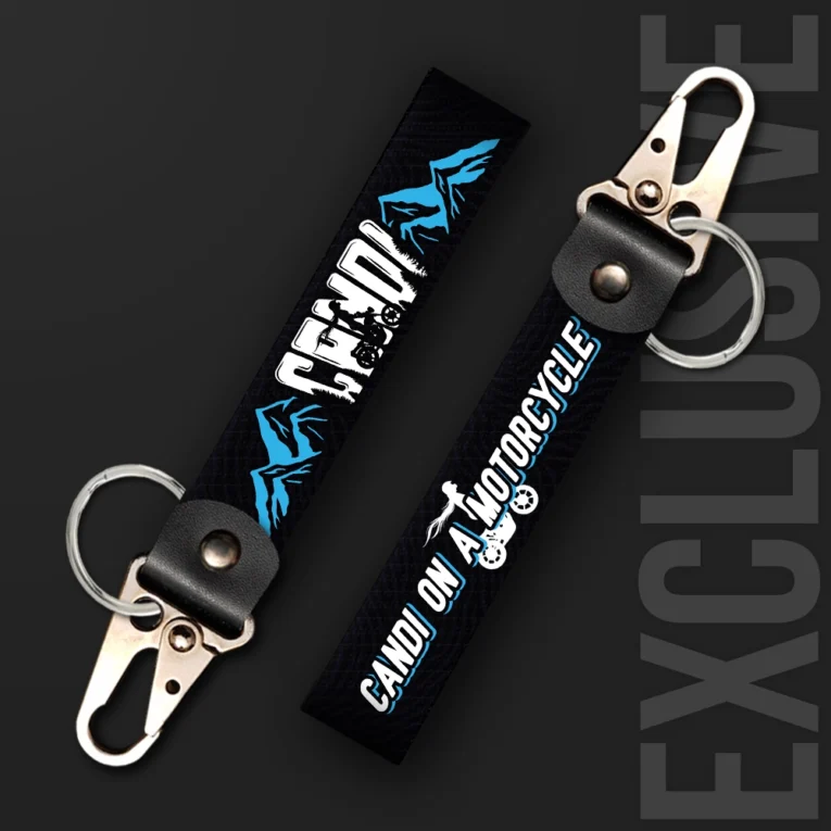 Inline-4 Candi on a Motorcycle keychain strap with a blue mountain illustration, 'CANDI' text, and a rider silhouette icon on black, swivel hook clip + keyring