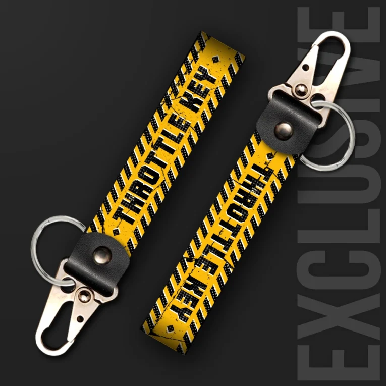 Inline-4 Throttle Key keychain strap with black 'THROTTLE KEY' text over a yellow and black hazard-stripe tire-tread pattern, swivel hook clip + keyring