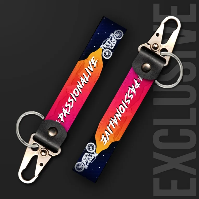 Inline-4 Passionalive keychain strap with white 'PASSIONALIVE' text over a pink-to-orange sunset gradient and a motorcycle silhouette, swivel hook clip + keyring
