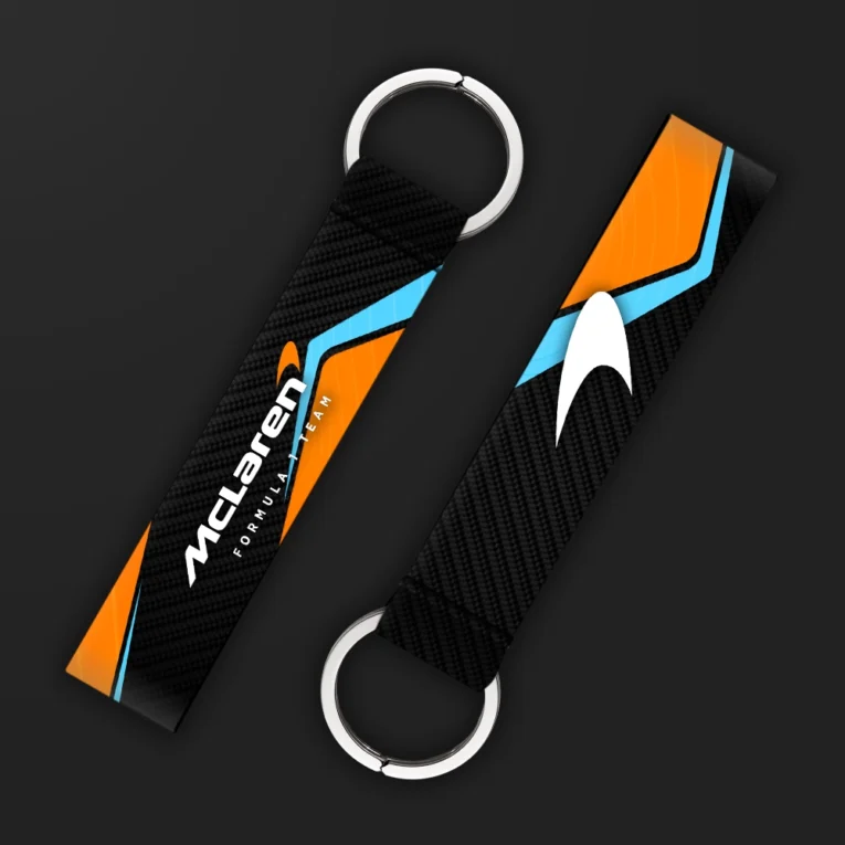 Inline-4 racing tribute keychain strap in McLaren-inspired orange and blue with an arrow-mark graphic, double keyring