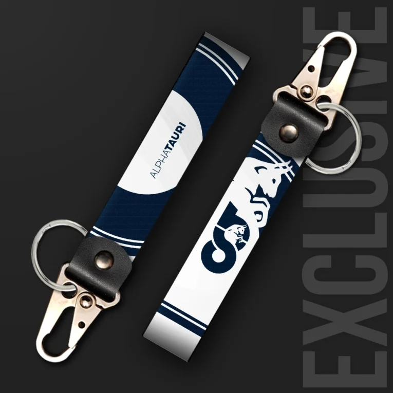 Inline-4 racing tribute keychain strap in navy and white with a bull emblem and racing team wordmark, swivel hook clip + keyring