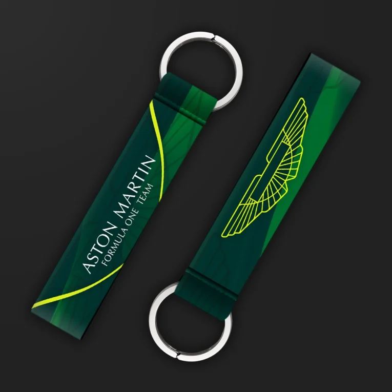 Inline-4 racing tribute keychain strap in British racing green with a wing emblem and racing team wordmark, double keyring