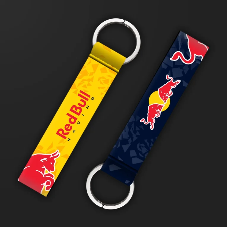 Inline-4 racing tribute keychain strap in navy and yellow with two charging-bull graphics and 'RACING' wordmark, double keyring