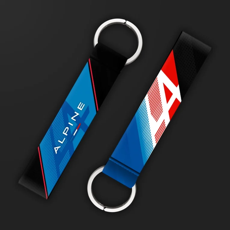 Inline-4 racing tribute keychain strap in blue and red with a stylized 'A' emblem and 'ALPINE' wordmark, double keyring