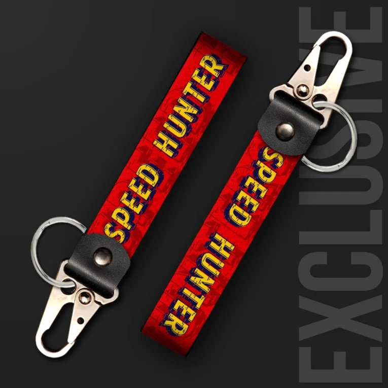 Inline-4 Speed Hunter keychain strap with a vintage red and yellow 'SPEED HUNTER' wordmark on a distressed grille-pattern background, swivel hook clip + keyring