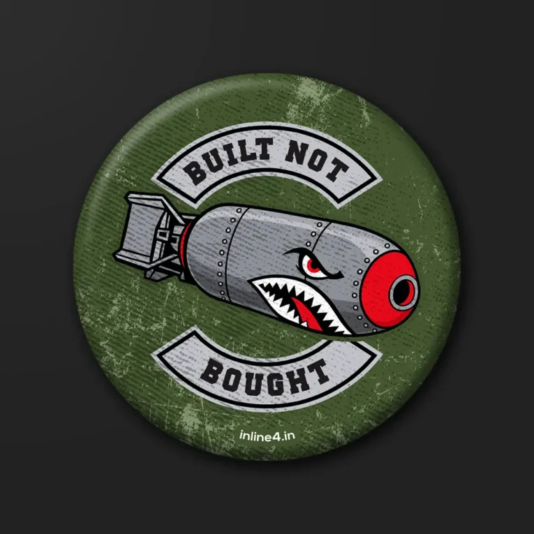 Built Not Bought badge, a shark-mouth bomb with a red nose between BUILT NOT and BOUGHT patches on olive green